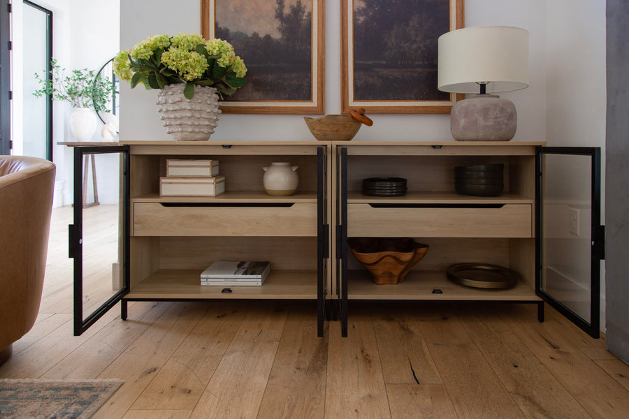 Glass-door console styled with art, a lamp and hydrangeas