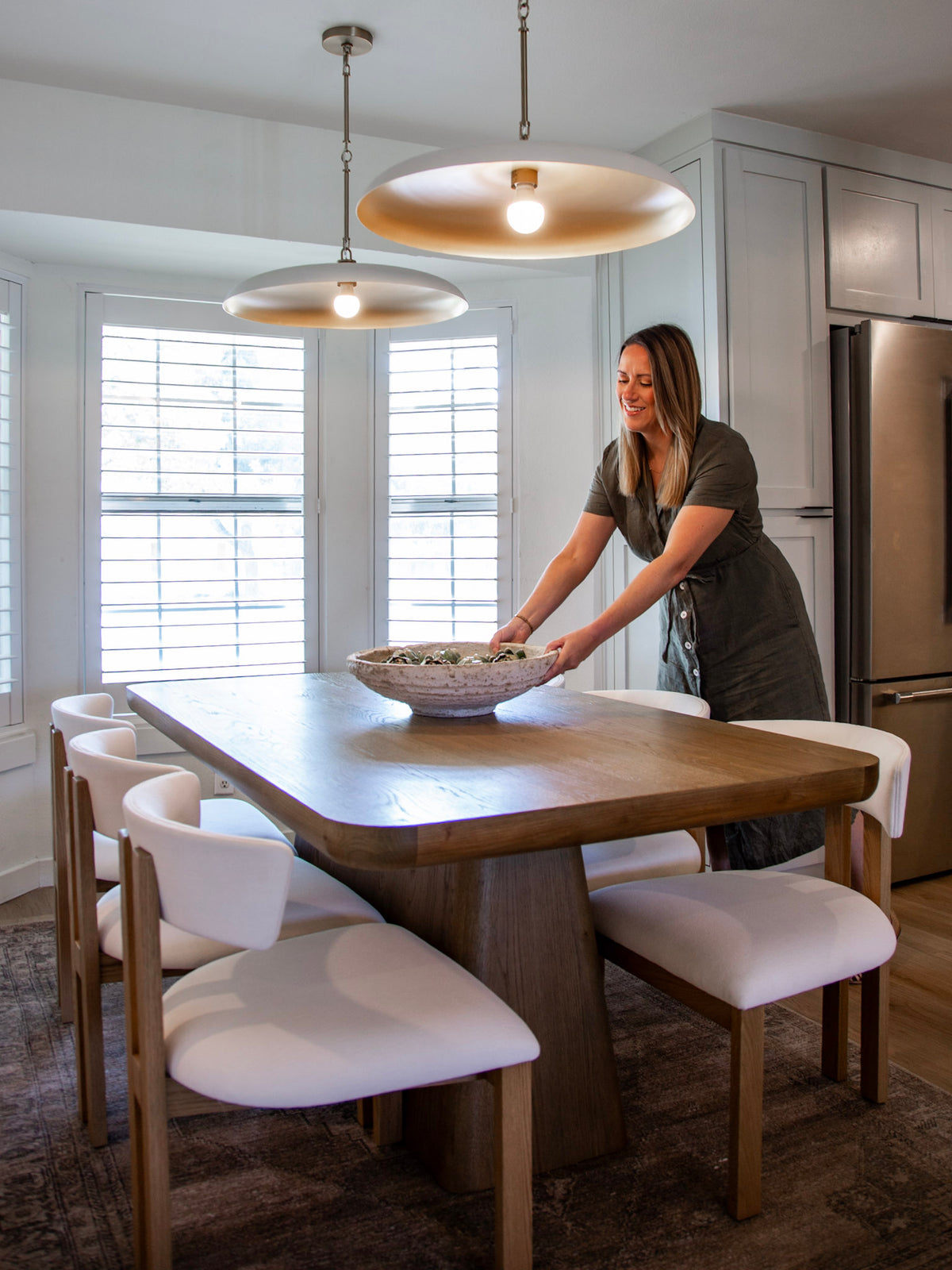 Jennie Neathery styling a dining table with a wood bowl